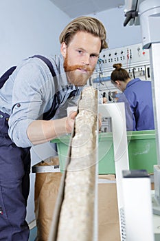 young mechanical worker looking at machine