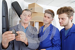 Young mechanics apprentices in workshop photo