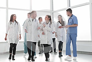 Young medical doctors striding through the hospital corridor