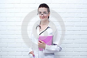 Young medical girl near the white wall