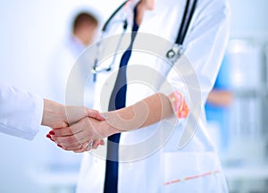 Young medical people handshaking at office