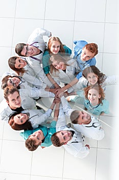 Young medical professionals standing among their colleagues