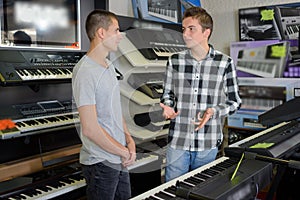 Young men discussing keyboards