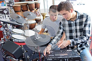 Young men with electronic drumkit and amp photo
