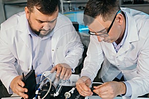 Young men are engaged in setting up a water purifier