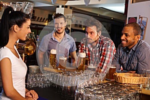 Young men flirting with bartender in pub