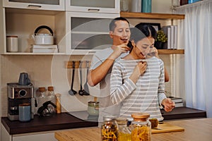 Young man giving his girlfriend necklace as present. Asian woman getting surprised by her boyfriend with marriage