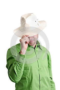 Young men hiding behind his hat photo