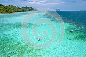 Young men in a kayak at the bleu turqouse colored ocean of Koh Kradan Thailand