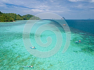 Young men in a kayak at the bleu turqouse colored ocean of Koh Kradan Thailand