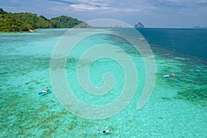 Young men in a kayak at the bleu turqouse colored ocean of Koh Kradan Thailand