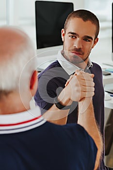Power dynamic in friendly work handshake contest photo