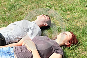 Couple of lovers lying on meadow