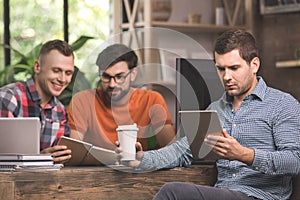 Young men programmers working together in the office