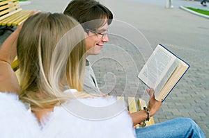 Young men reading a book