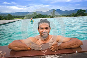 Young men relaxing in a waterpool