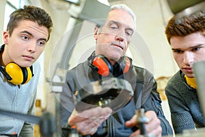 Young men and senior - mechanical engineer class