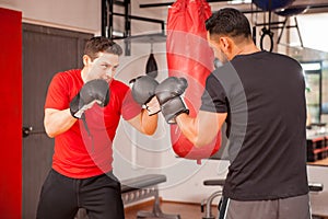 Young men sparring in boxing room