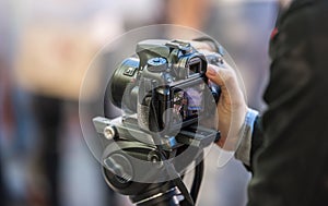 young men takes video with camera on tripod