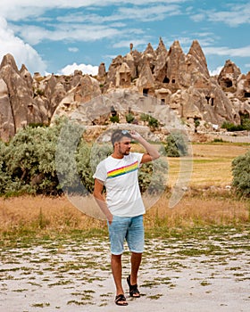 Young men on vacation Cappadocia Turkey sunrise in the hills with hot air balloons, Kapadokya Beautiful vibrant colorful