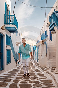 Young men on vacation Greece, Mykonos Greece, Little Venice Mykonos Greece, sunset at ocean fron at Mykonos town