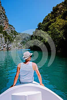 Young men view to the cliffy rocks of Verdon Gorge at lake of Sainte Croix, Provence, France, near Moustiers Sainte