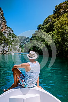 Young men view to the cliffy rocks of Verdon Gorge at lake of Sainte Croix, Provence, France, near Moustiers Sainte