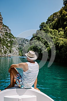 Young men view to the cliffy rocks of Verdon Gorge at lake of Sainte Croix, Provence, France, near Moustiers Sainte