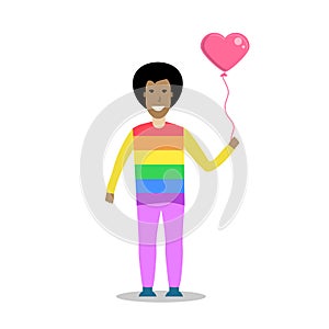 Young men wearing a rainbow t shirt and holding a heart shape balloon.