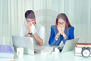 Sick sneezing colleagues in office photo