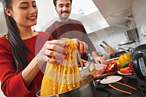 Young couple having romantic evening at home in the kitchen cooking meal together close-up