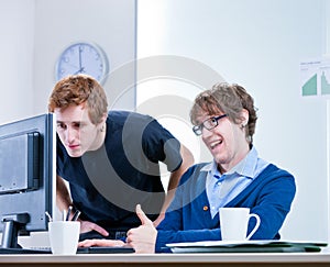 Young men working together in an office