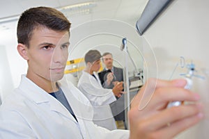 Young man writing on easel