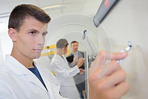 Young man writing on whiteboard