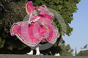 A young mexican woman folk dancer with traditional costume photo