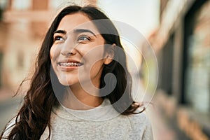 Young middle east girl smiling happy standing at the city