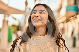 Young middle east girl smiling happy standing at the city