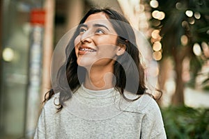 Young middle east girl smiling happy standing at the city