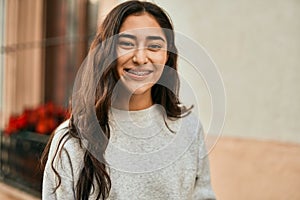 Young middle east girl smiling happy standing at the city