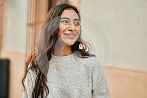 Young middle east girl smiling happy standing at the city