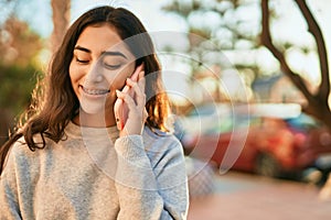 Young middle east girl smiling happy talking on the smartphone at the city