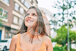 Young middle east girl smiling happy walking at the city