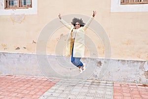 Young middle east woman excutive smiling confident jumping at street