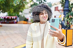 Young middle east woman excutive smiling confident make selfie by smartphone at park