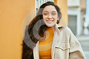 Young middle east woman smiling happy standing at the city