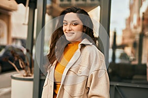 Young middle east woman smiling happy standing at the city