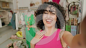 Young middle eastern woman customer smiling confident having video call at clothing store