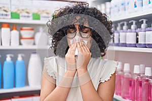 Young middle eastern woman customer using nakpin at pharmacy