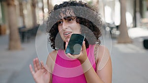 Young middle eastern woman smiling confident talking on the smartphone at street