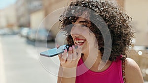 Young middle eastern woman smiling confident talking on the smartphone at street
